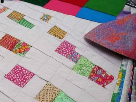 lining-up-pieces-of-fabric-for-memory-quilt